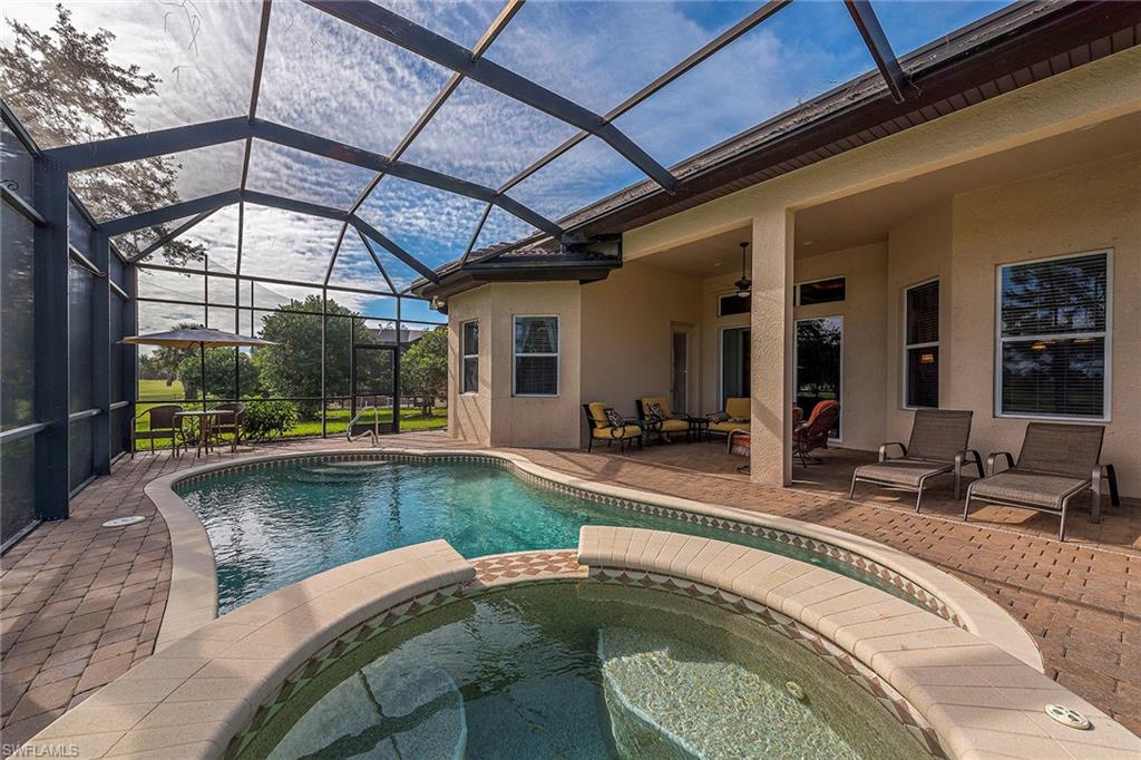 7812 Valencia Court Naples, FL 34113 - Photo 11 of 12 a view of a swimming pool with a patio