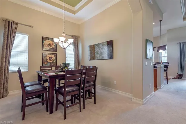 a view of a dining room with furniture and a chandelier