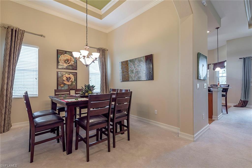 7812 Valencia Court Naples, FL 34113 - Photo 4 of 12 a view of a dining room with furniture and a chandelier