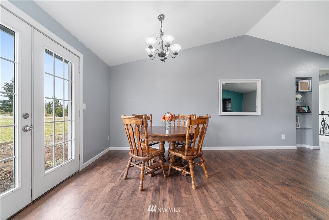 7810 196th Lane Southwest Rochester, WA 98579 - Photo 8 of 36 a view of a dining room with furniture window and wooden floor