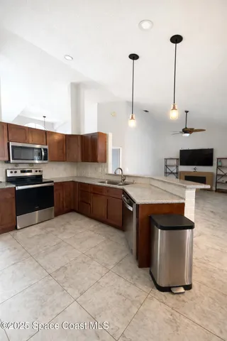 a kitchen with stainless steel appliances kitchen island granite countertop a sink and a stove