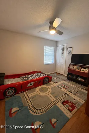 a bedroom with a bed and a chandelier