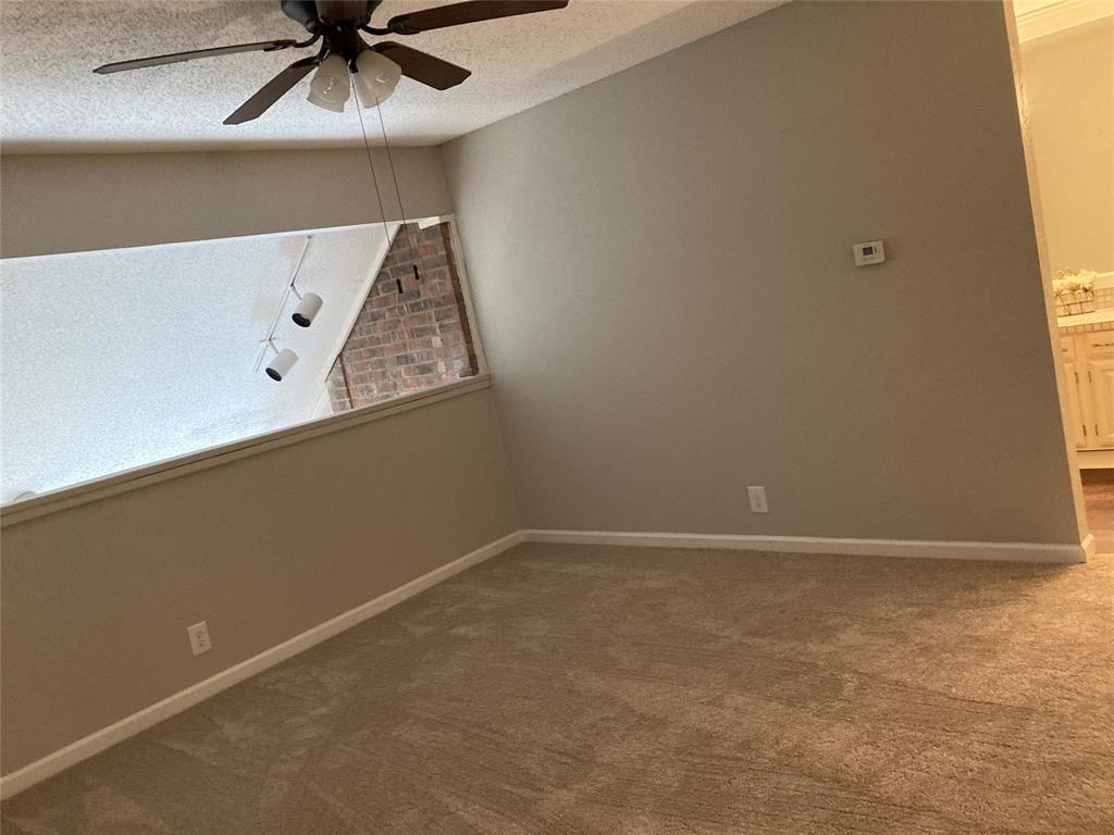 18240 Midway Road, Unit 905 Dallas, TX 75287 - Photo 8 of 15 Carpeted empty room with a textured ceiling and ceiling fan