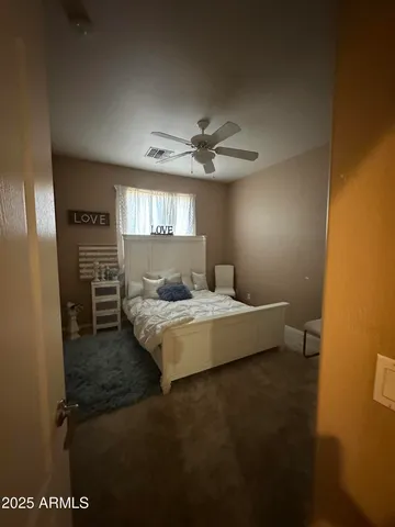 a bedroom with a bed and a night stand