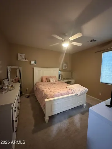 a bedroom with bed and window