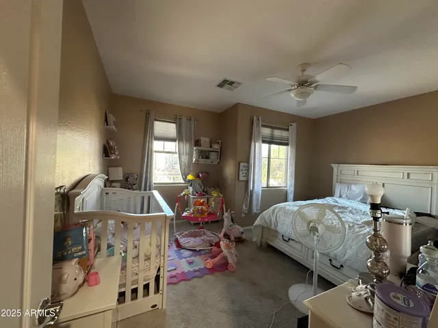 a bedroom with furniture and a lamp