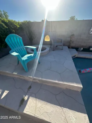 a view of a patio with lawn chairs floor to ceiling window and wooden floor