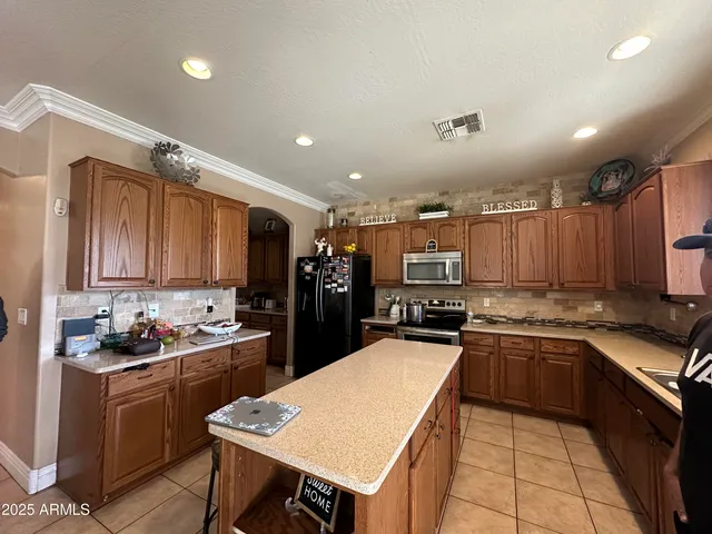 a living room with lots of furniture and view of kitchen