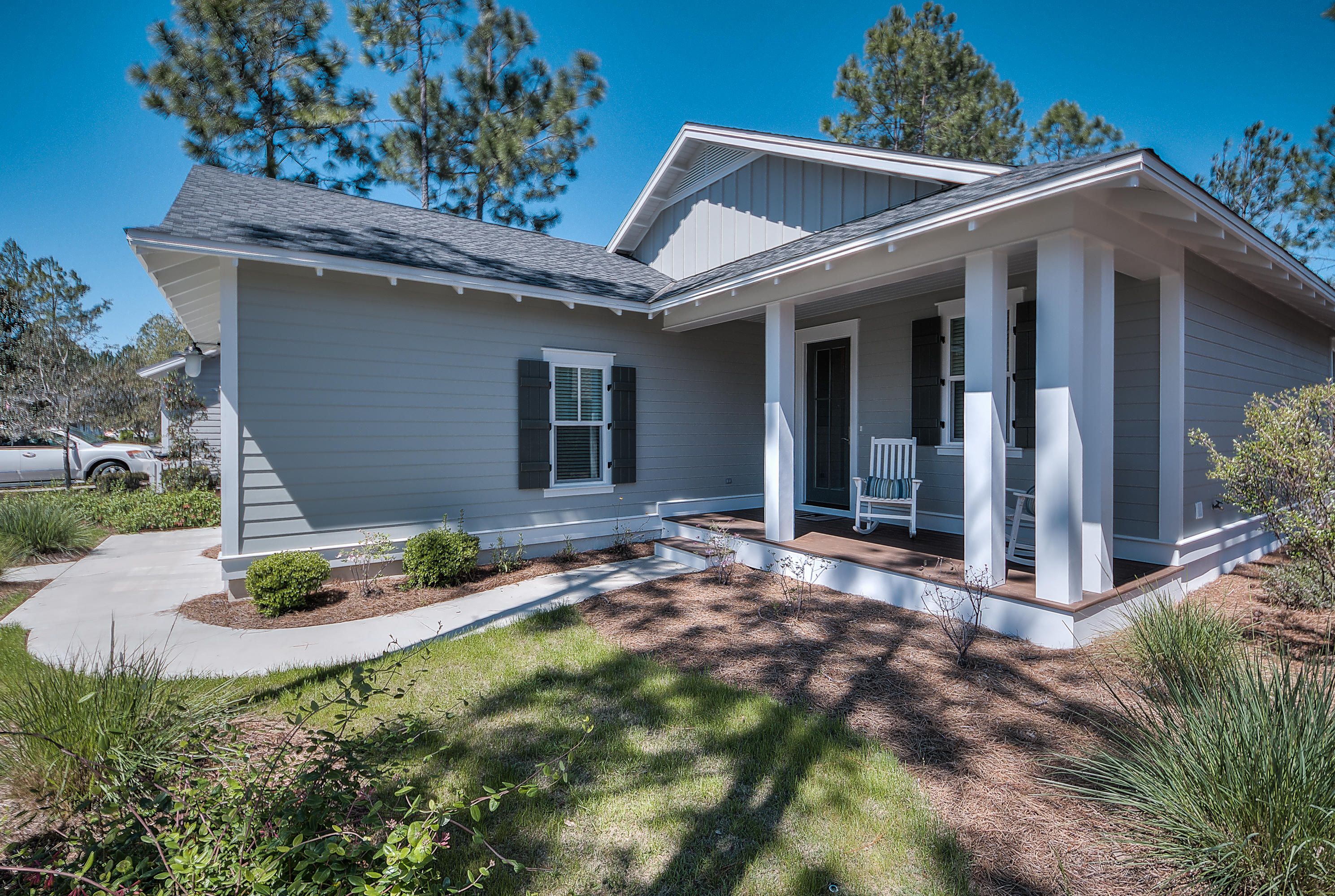 137 Sidecamp Road, Unit LOT 50 Watersound, FL 32461 - Photo 3 of 26 a backyard of a house with plants and outdoor seating