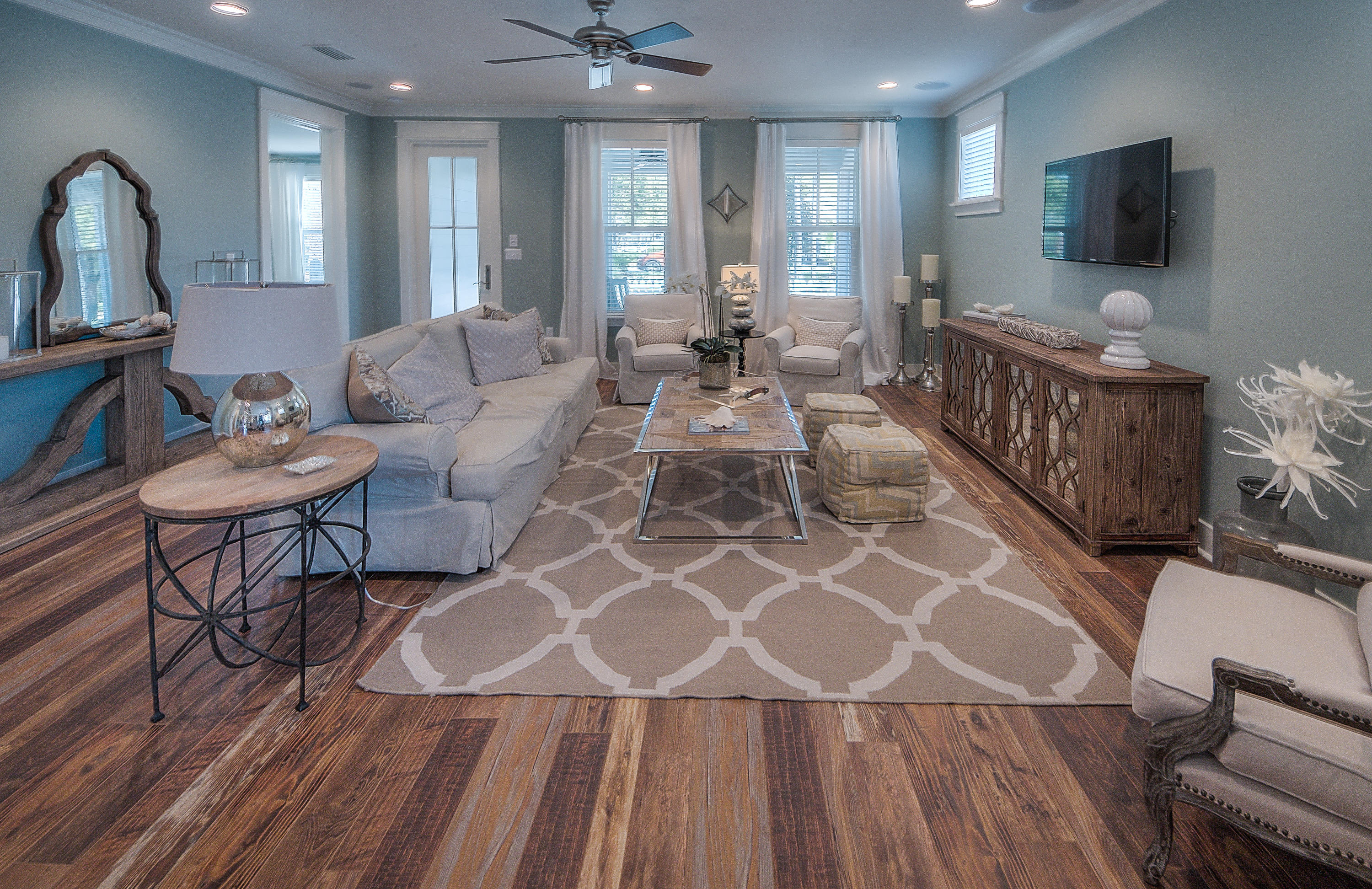 137 Sidecamp Road, Unit LOT 50 Watersound, FL 32461 - Photo 8 of 26 a living room with furniture a flat screen tv and large window