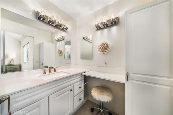 a bathroom with a sink vanity and a mirror