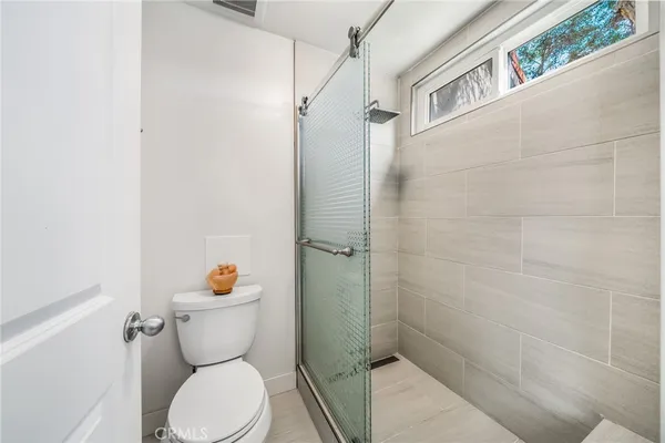 a white toilet sitting next to a bathroom sink
