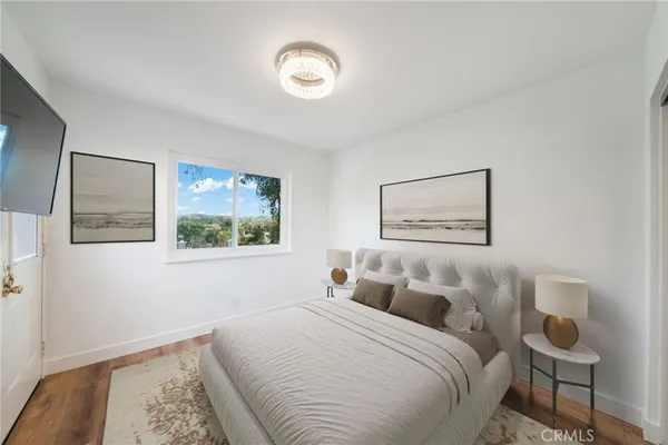a bedroom with a bed and a painting on the wall