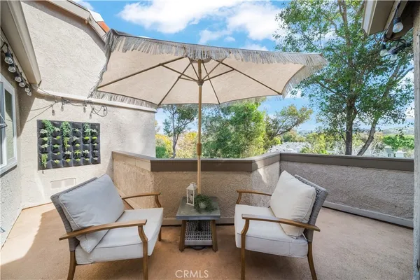 a balcony with table and chairs