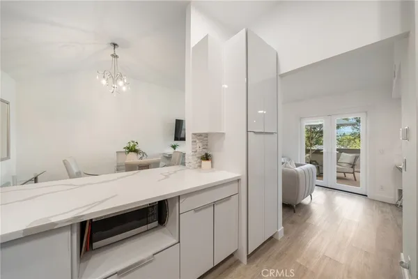 a bathroom with a sink double vanity granite tub and a mirror