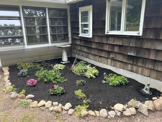 45 Moco Road Barnstable, MA 02668 - Photo 11 of 14 a front view of a house with a yard and flowers in it