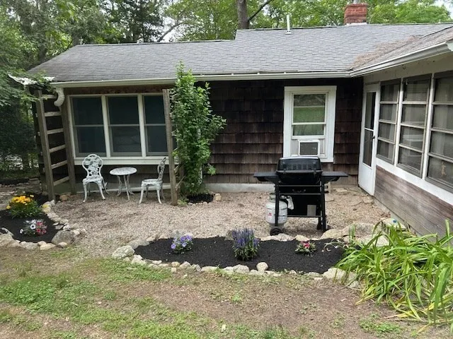 a backyard of a house with outdoor seating