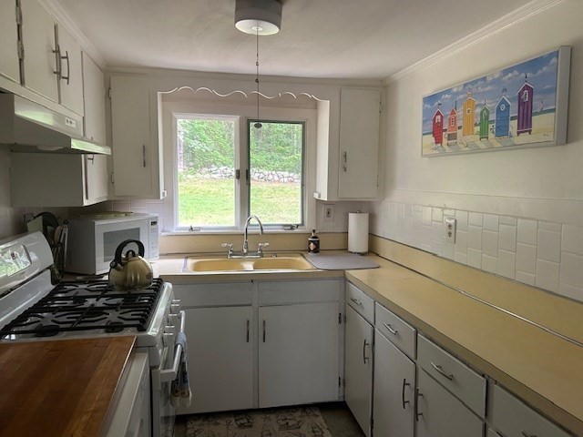 45 Moco Road Barnstable, MA 02668 - Photo 6 of 14 a kitchen with a sink stove and cabinets