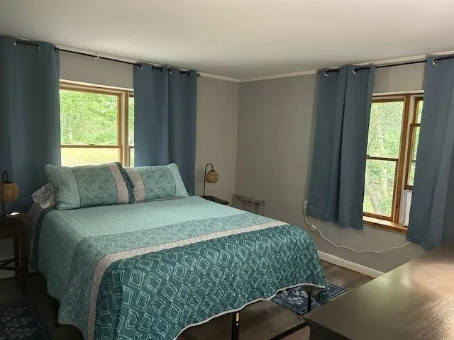 a bedroom with a bed and a window