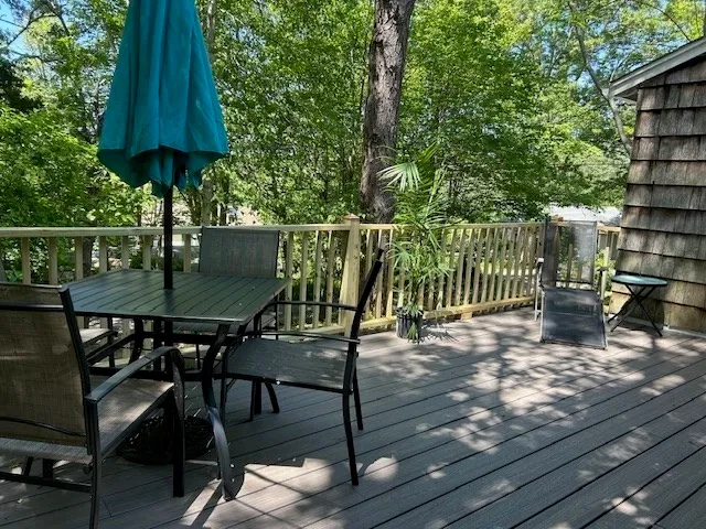 a view of balcony with wooden floor and outdoor seating