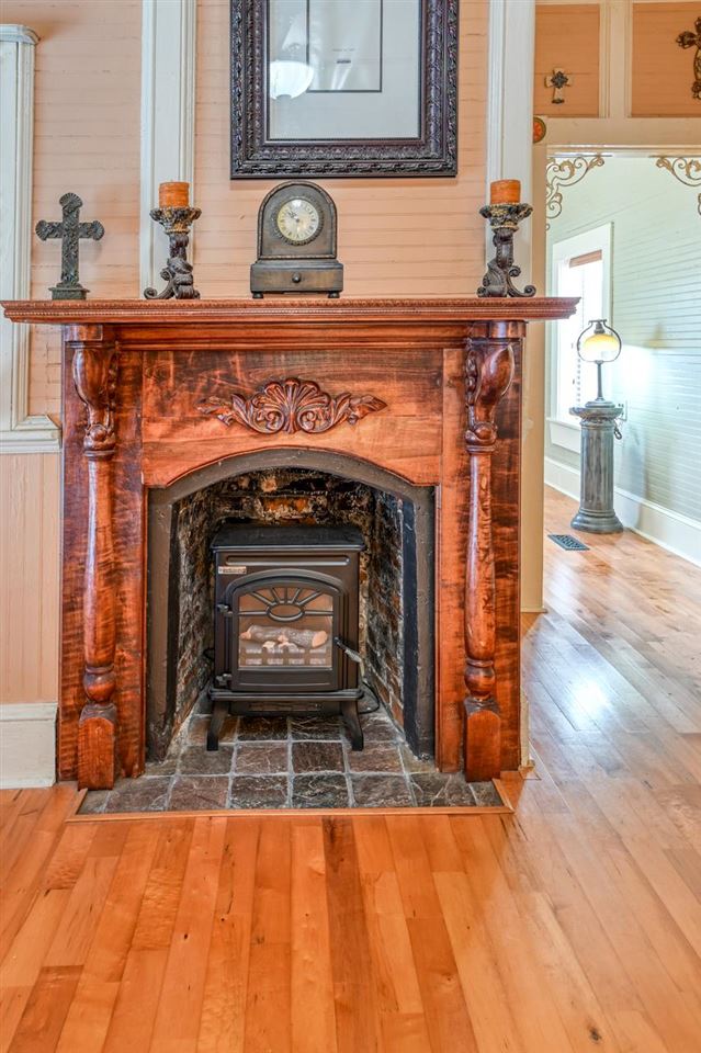 9095 Reid Packing House Road Hastings, FL 32145 - Photo 42 of 50 a kitchen with a fireplace and wooden floor