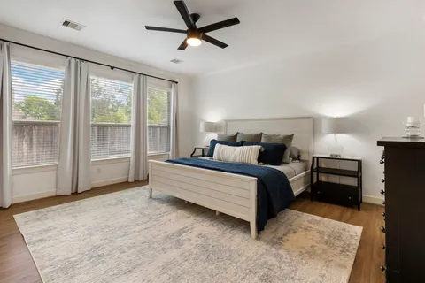 a view of a backyard with a barbeque and a large tree