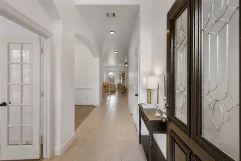 a view of a hallway with wooden floor and staircase