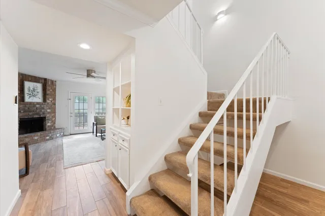 a view of a patio with couple of chairs and potted plants