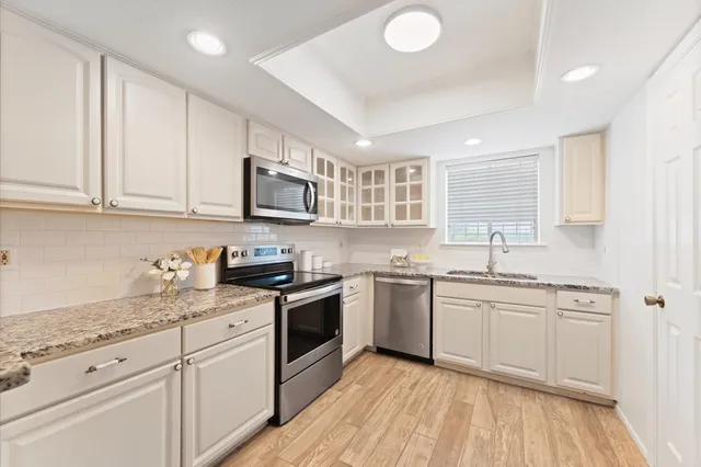 a view of a closet with wooden floor and a bathroom