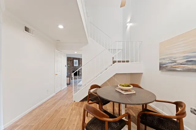 a view of a white house with a yard and sitting area