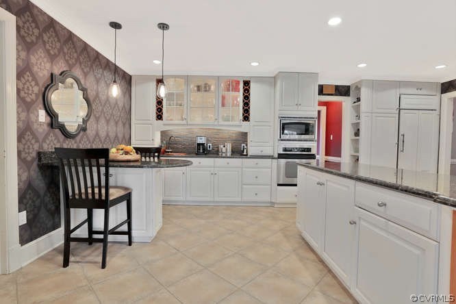 1821 Castlebridge Road Midlothian, VA 23113 - Photo 12 of 40 a kitchen with stainless steel appliances kitchen island granite countertop a sink and cabinets