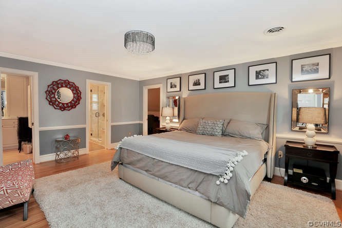 1821 Castlebridge Road Midlothian, VA 23113 - Photo 25 of 40 a spacious bedroom with a bed and a chandelier