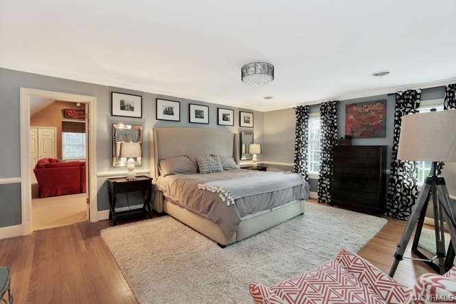 1821 Castlebridge Road Midlothian, VA 23113 - Photo 28 of 40 a bedroom with a large bed and a chandelier