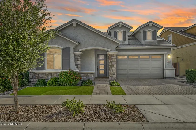 a front view of a house with a yard and garage