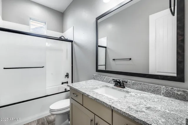 a kitchen with stainless steel appliances granite countertop a sink a stove and a wooden floors