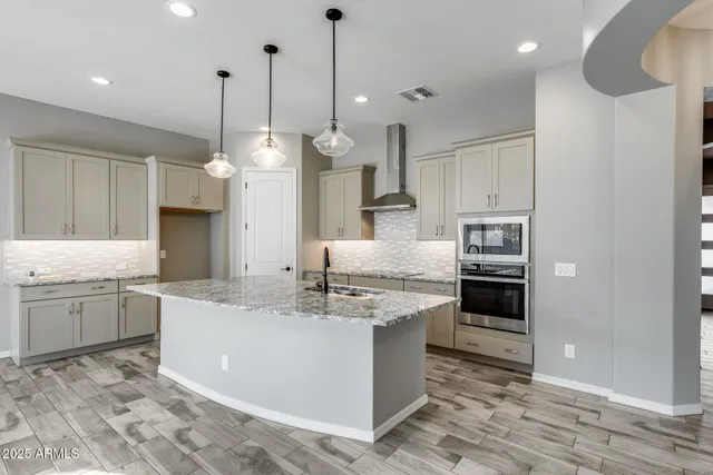 a utility room with sink dryer and washer