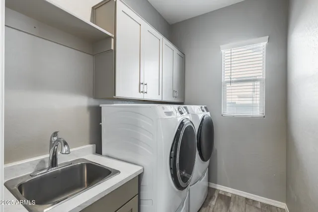 a backyard of a house with lots of green space and brick wall