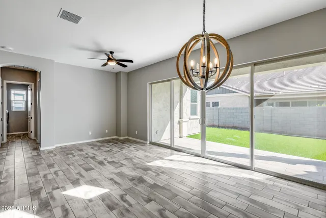 a front view of a house with a yard and tree s