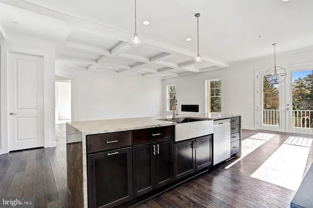 a kitchen with kitchen island a sink and a wooden floor