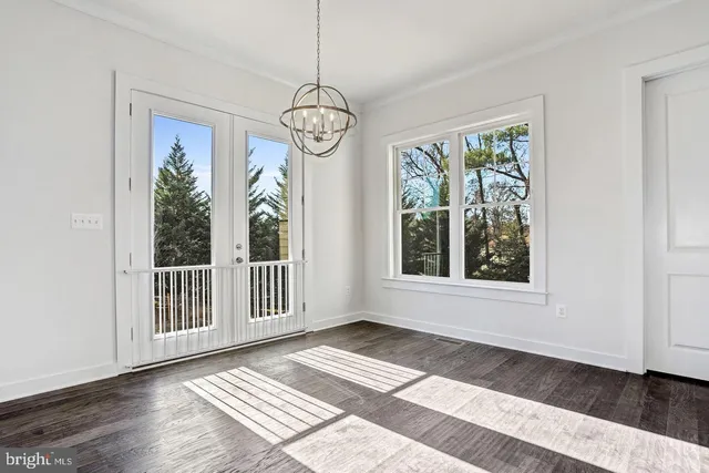 a view of a room with wooden floor and windows
