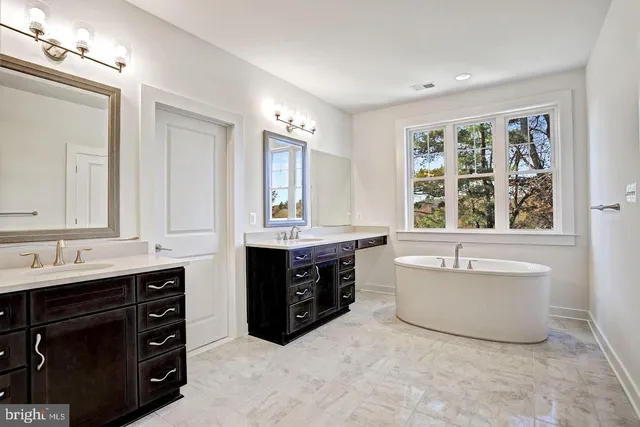 a bath room with a sink and a window