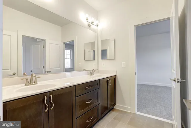 a bathroom with a double vanity sink and a mirror