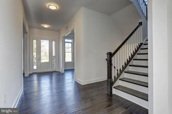 a view of entryway with wooden floor and stairs