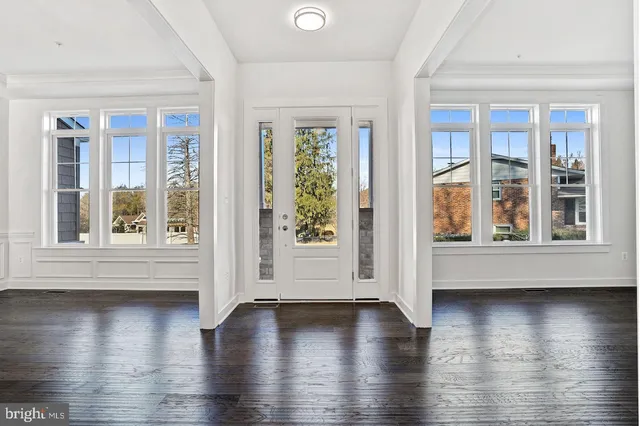 a view of an entryway with wooden floor
