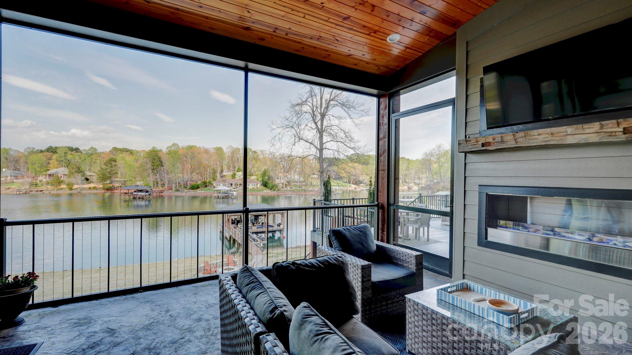 644 Normandy Road Mooresville, NC 28117 - Photo 12 of 32 a living room with furniture a flat screen tv and a floor to ceiling window