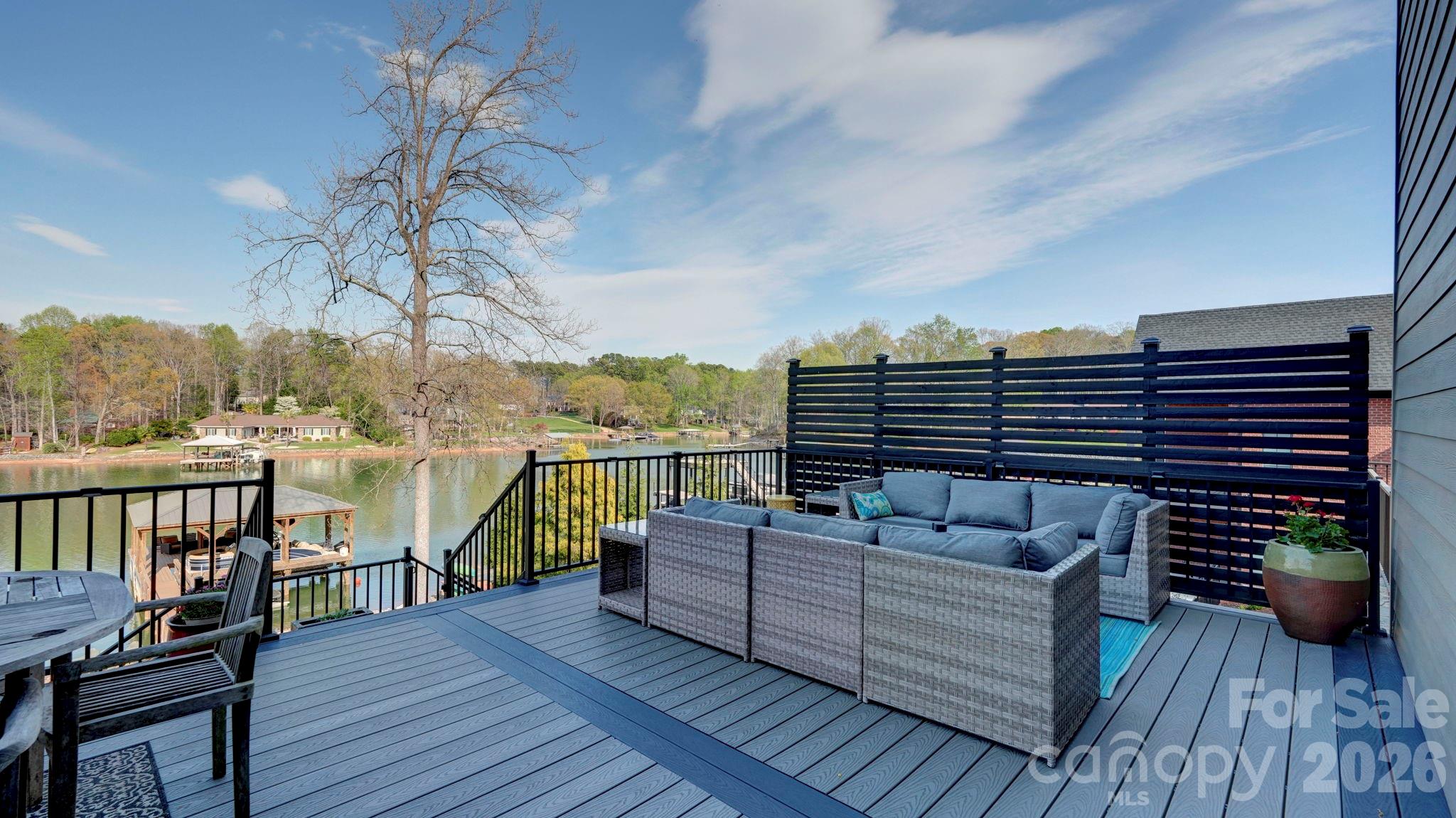644 Normandy Road Mooresville, NC 28117 - Photo 17 of 32 a view of a balcony with two chairs and a wooden floor