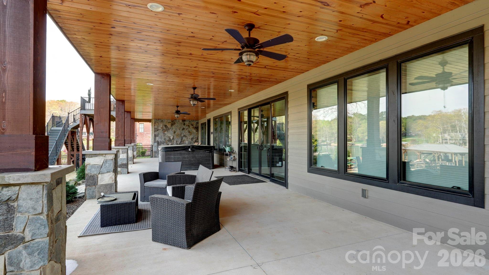 644 Normandy Road Mooresville, NC 28117 - Photo 27 of 32 a view of a patio with a dining table chairs and iron gate