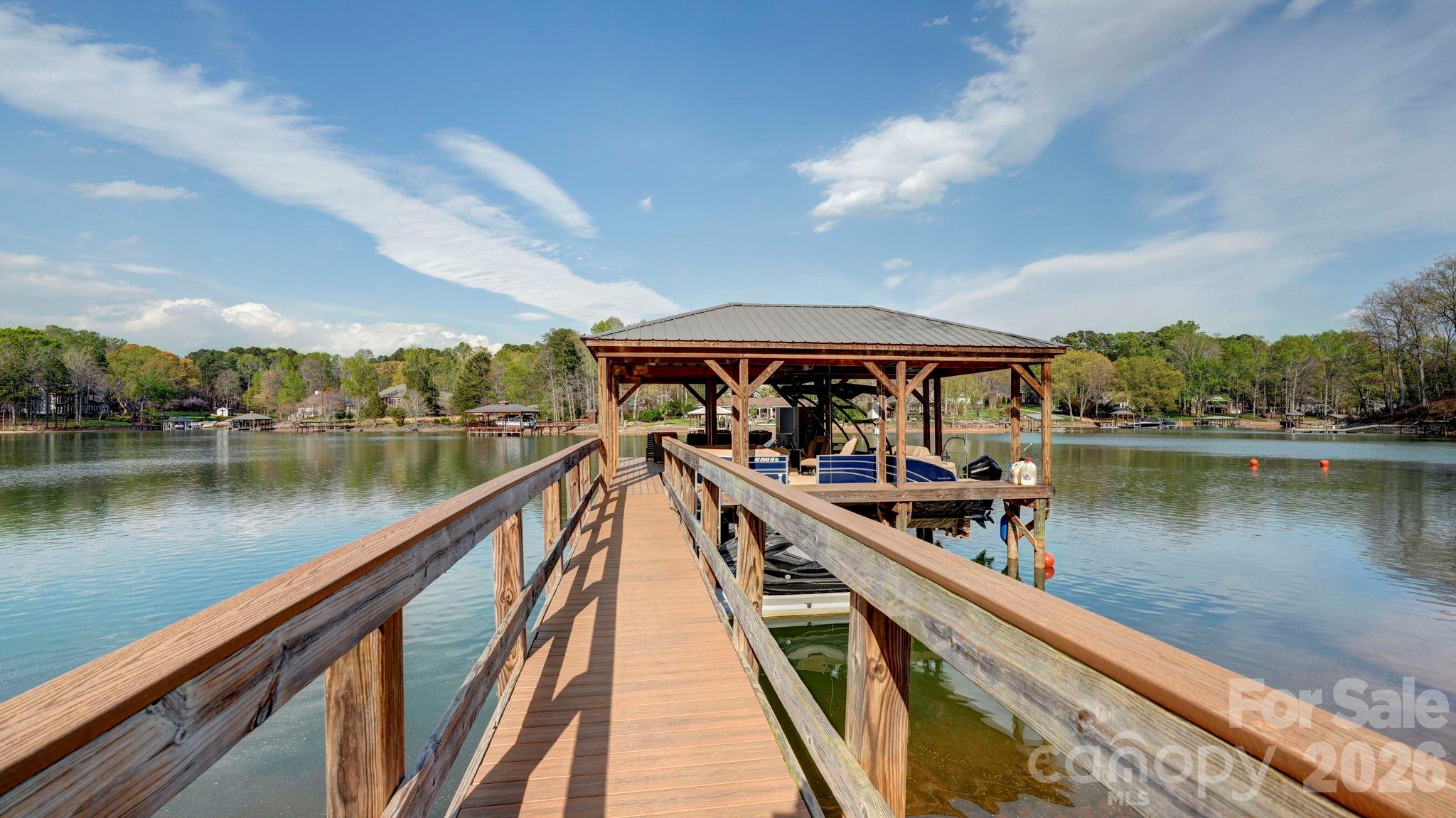 644 Normandy Road Mooresville, NC 28117 - Photo 28 of 32 a view of a lake with a deck