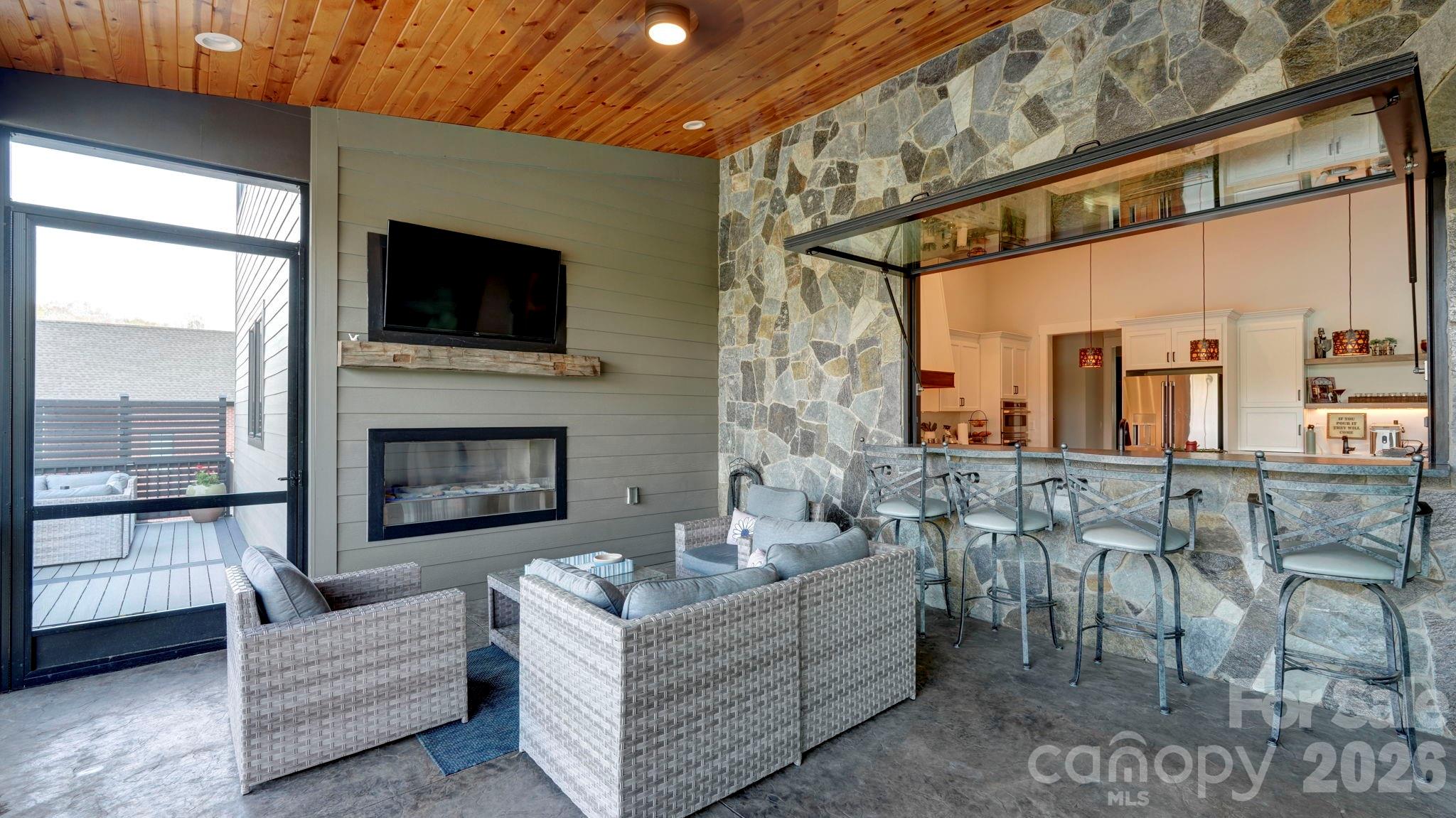 644 Normandy Road Mooresville, NC 28117 - Photo 10 of 32 a living room with furniture a flat screen tv and a fireplace