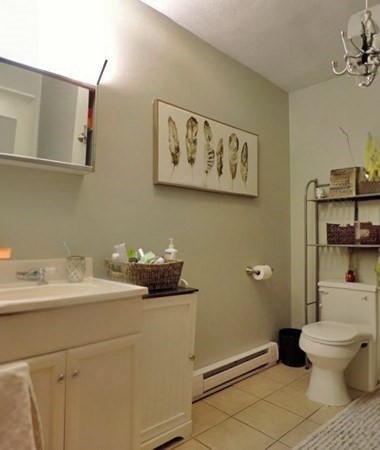 1-4 Schrepel Place Boston, MA 02127 - Photo 5 of 13 a bathroom with a toilet sink and mirror
